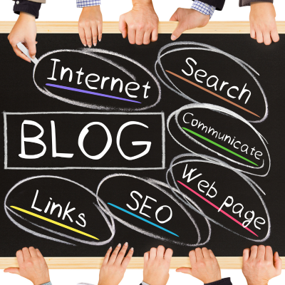 Hands point to a blackboard with words related to blogging and internet, such as "SEO" and "Links."